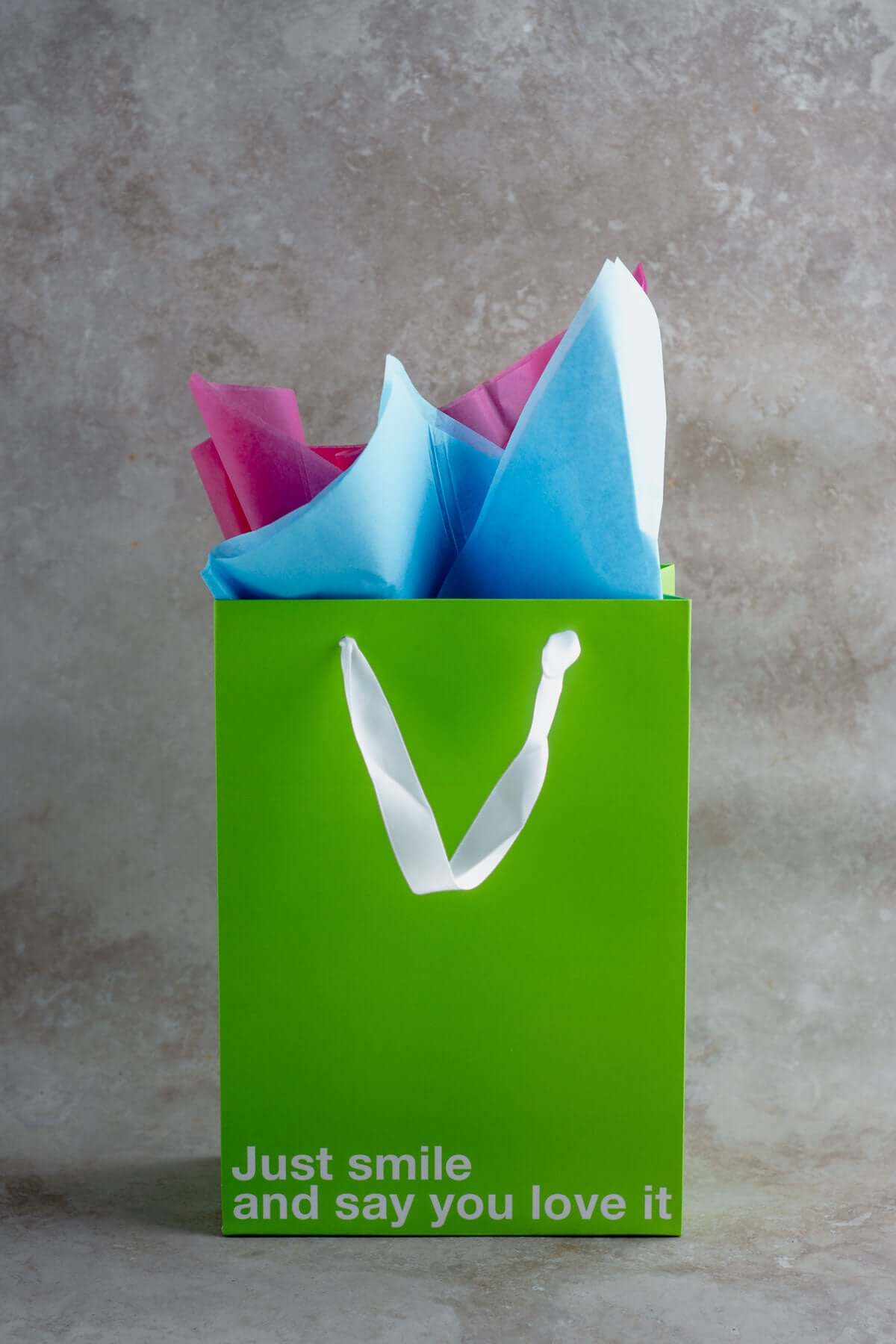 Colorful gift bag with the text 'Just smile and say you love it', part of a funny gift bags set.