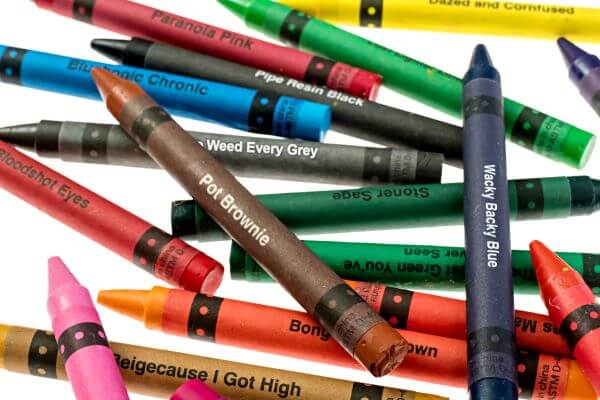 A colorful assortment of offensive crayons including Munchies Mango and Bong Water Brown.