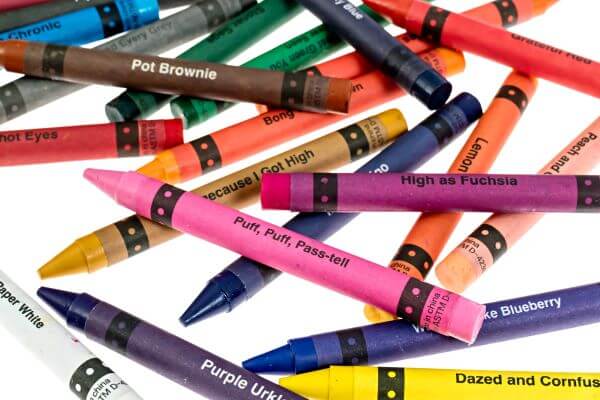 A vibrant assortment of offensive crayons in fun colors like Munchies Mango and Bong Water Brown.