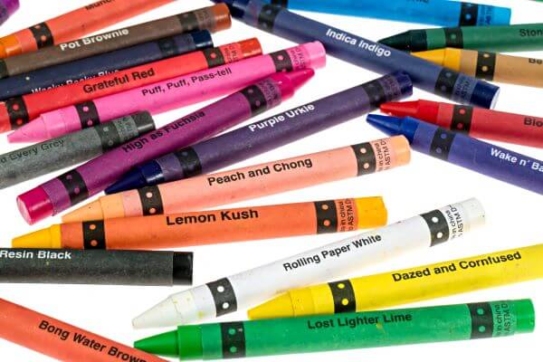 Colorful offensive crayons including Peach and Chong, Lemon Kush, and Bong Water Brown for creative sessions.
