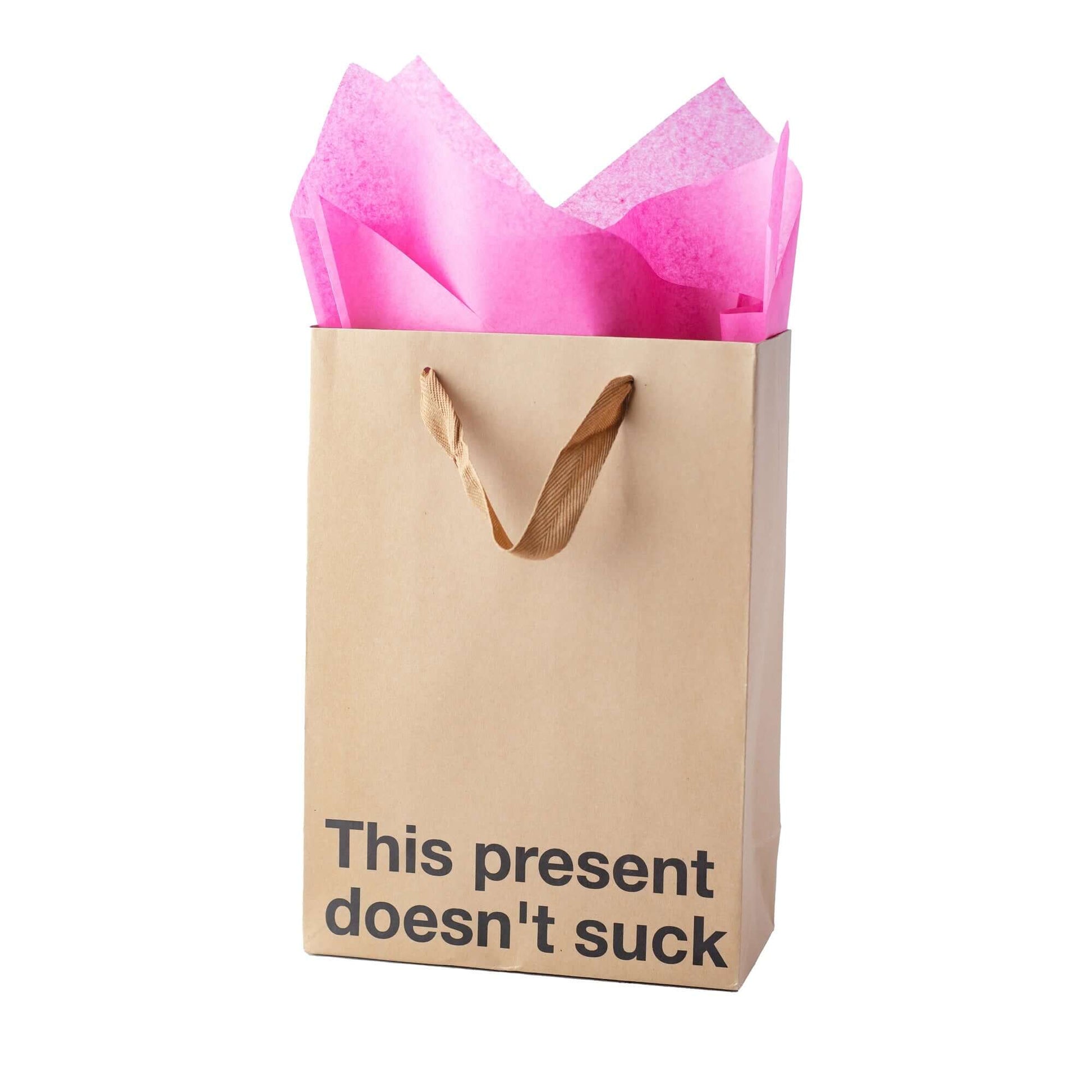 Funny gift bag with kraft material and pink tissue paper, saying 'This present doesn't suck'.