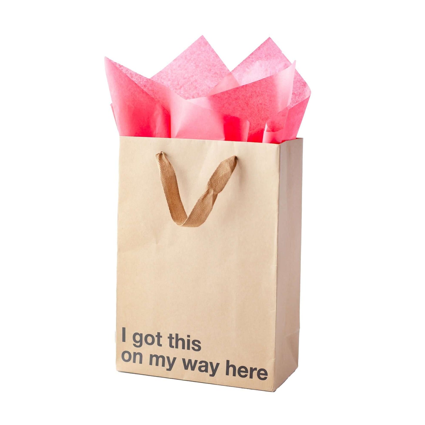 Funny gift bag with pink tissue paper, featuring the phrase 'I got this on my way here' in bold print.