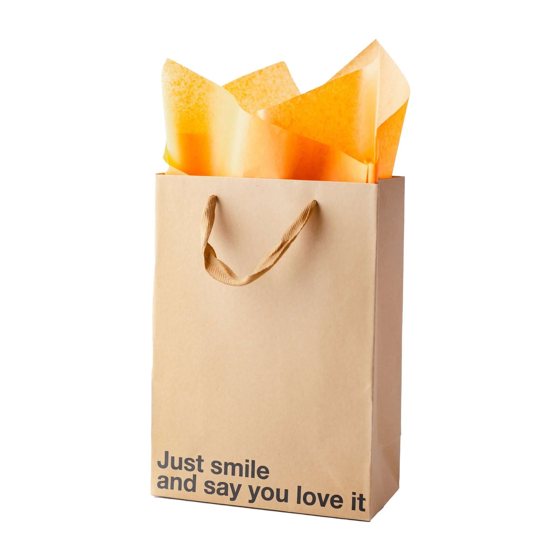 Just Smile gift bag with orange tissue paper, perfect for a funny gift bag, made of kraft material with a brown ribbon handle.