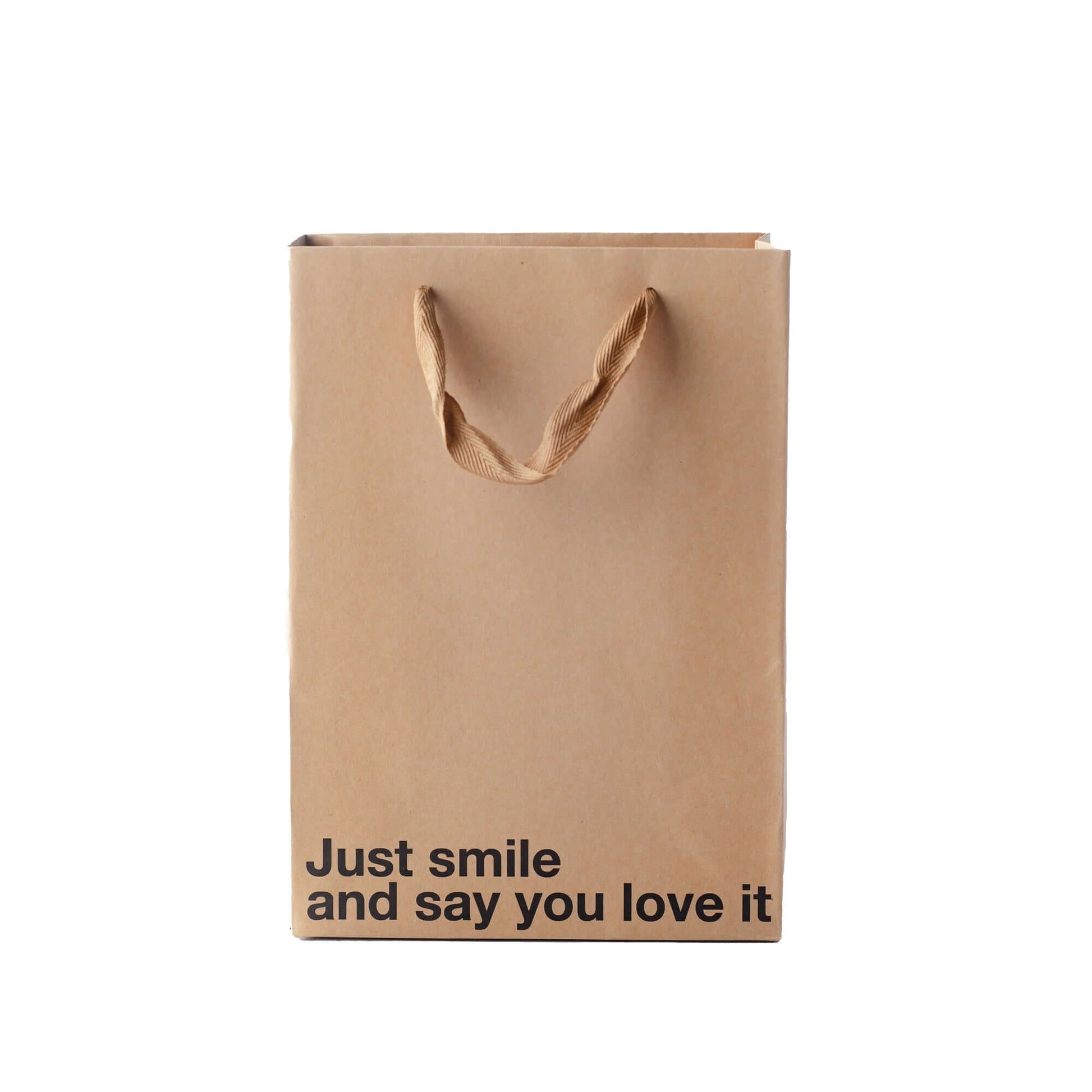 Just Smile gift bag made of kraft material with brown ribbon handle, featuring the text 'Just smile and say you love it', funny gift bag.