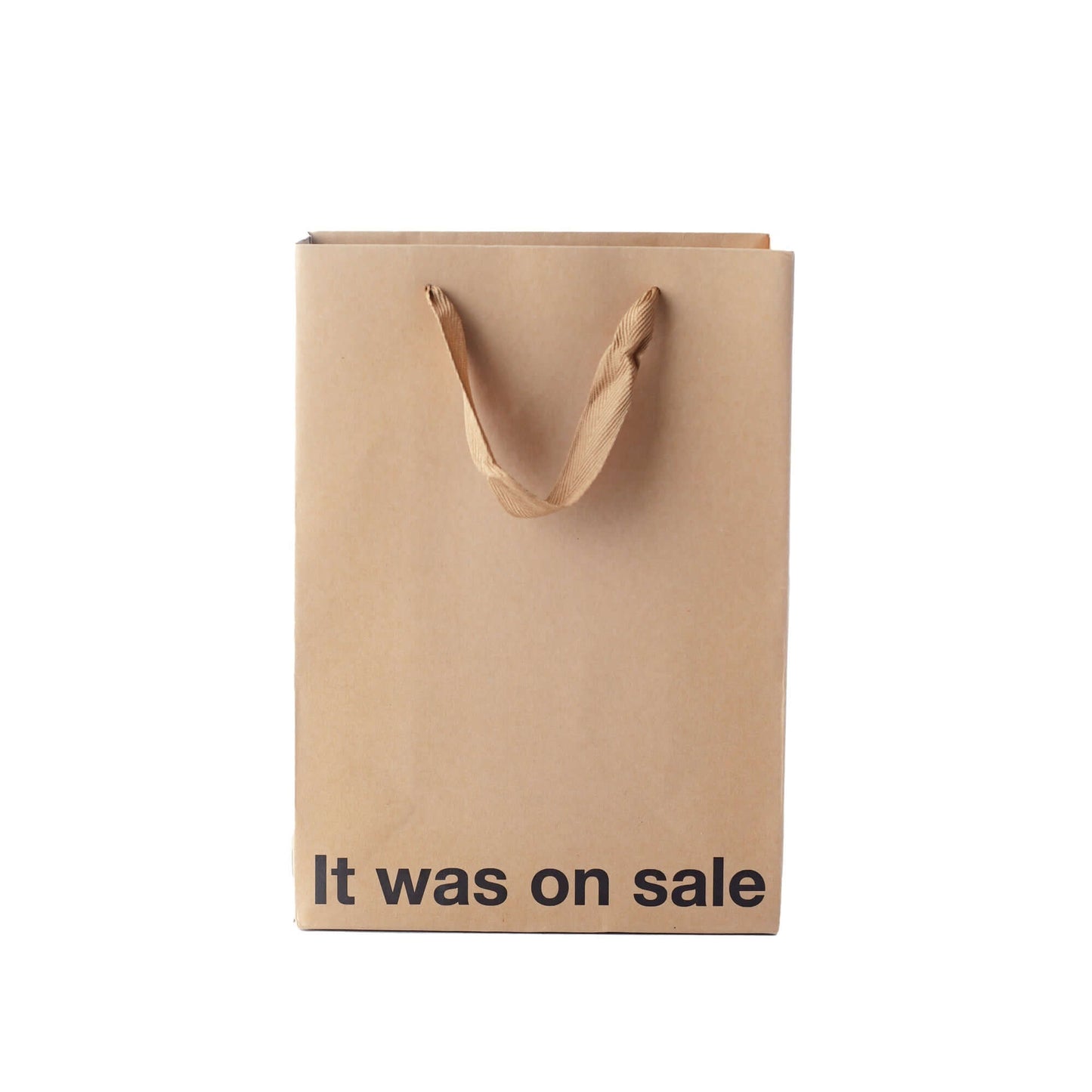Funny gift bag made of kraft material with brown ribbon handle and text that says 'It was on sale'.