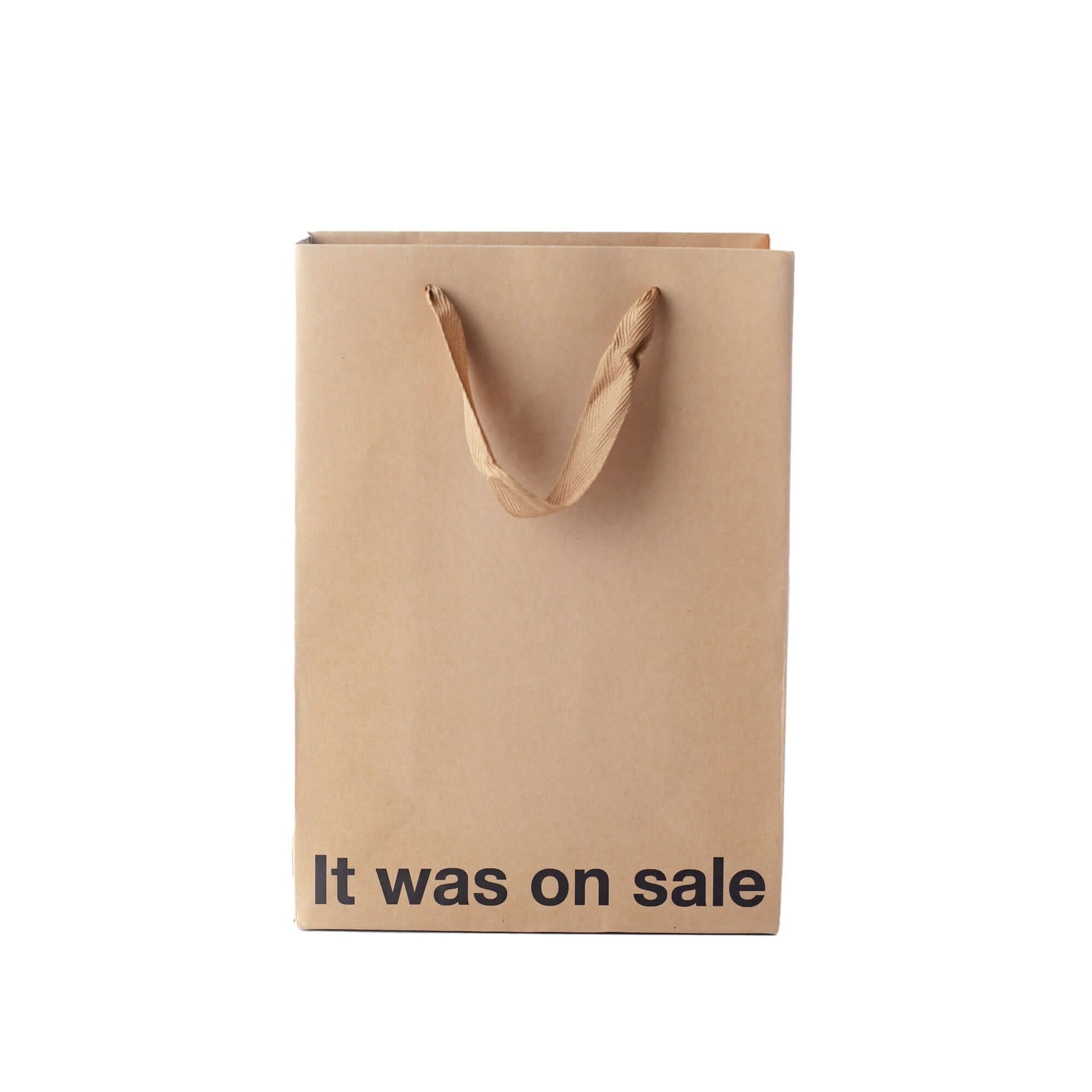 Funny gift bag made of kraft material with brown ribbon handle and text that says 'It was on sale'.