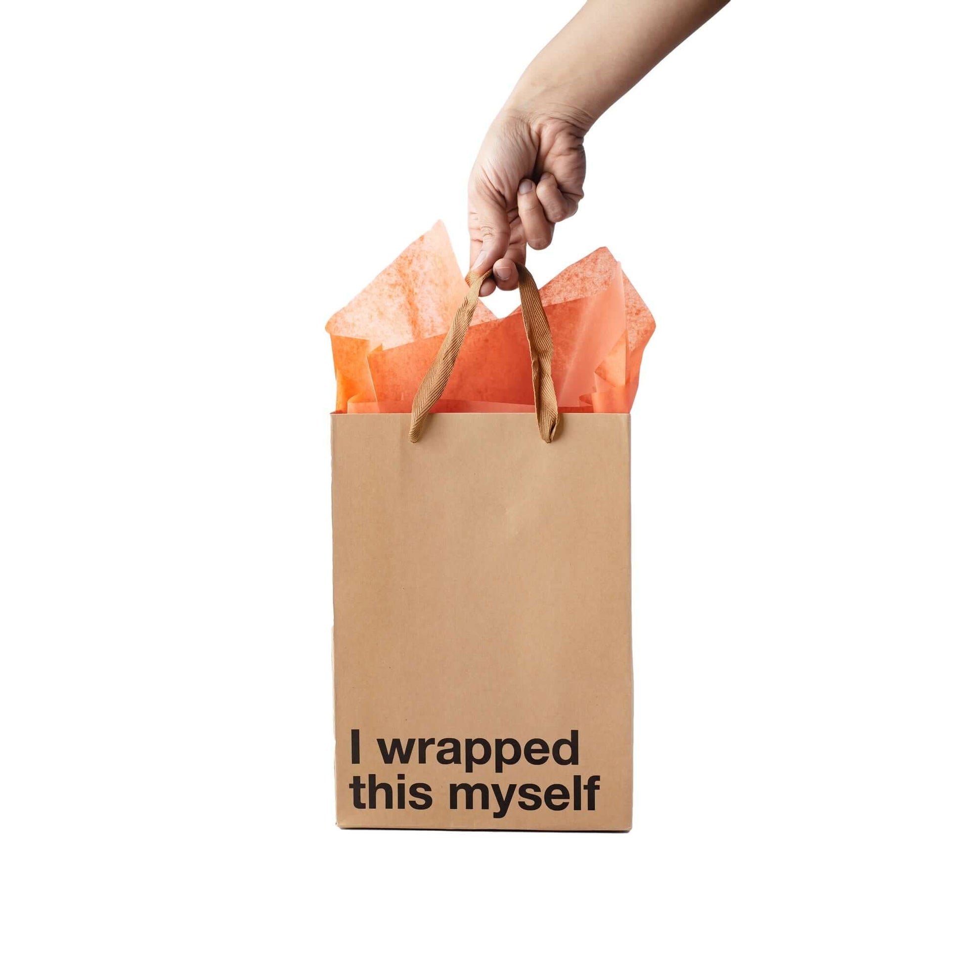 Hand holding a kraft gift bag with the text 'I wrapped this myself', featuring orange tissue paper inside, a funny gift bag.