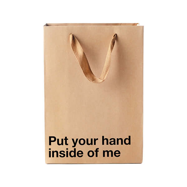 Funny gift bag with bold phrase "Put your hand inside of me" for humorous gifting at parties.