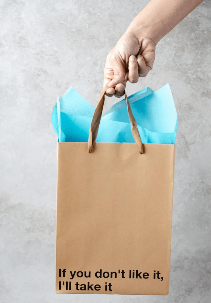 Funny gift bags featuring a kraft gift bag with blue tissue paper and the phrase 'If you don't like it, I'll take it'.