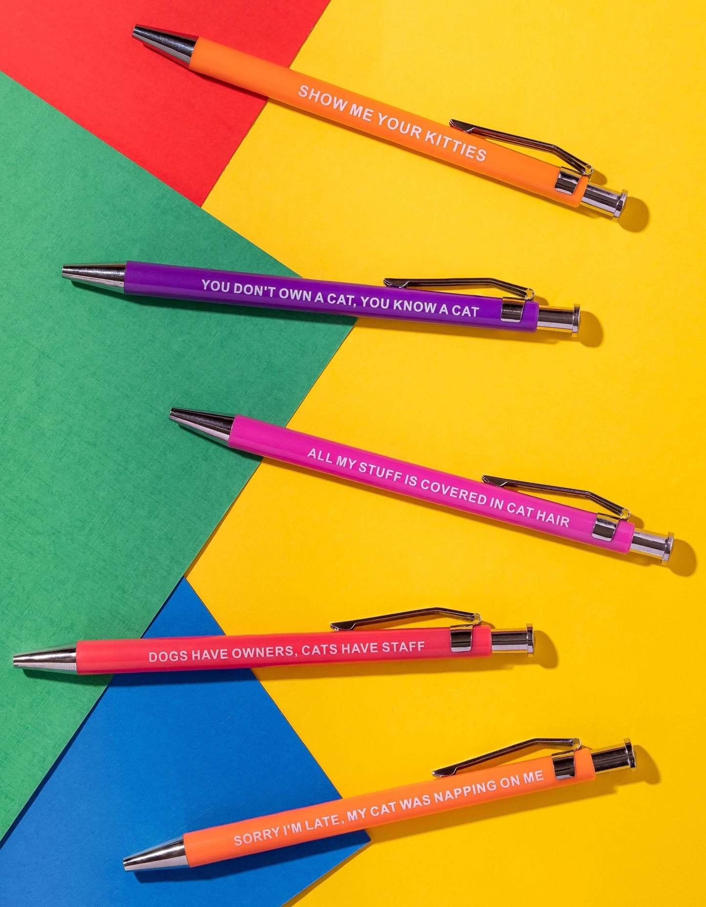 Sarcastic pens with colorful cat-themed designs and humorous sayings.