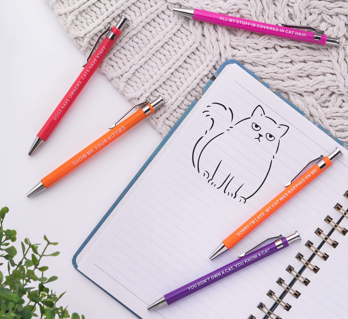 Sarcastic pens with colorful cat-themed designs and humorous sayings.