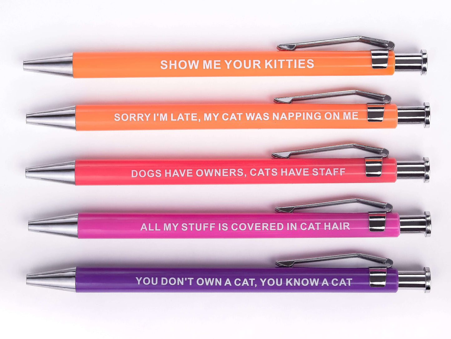 Sarcastic pens with colorful cat-themed designs and humorous sayings.
