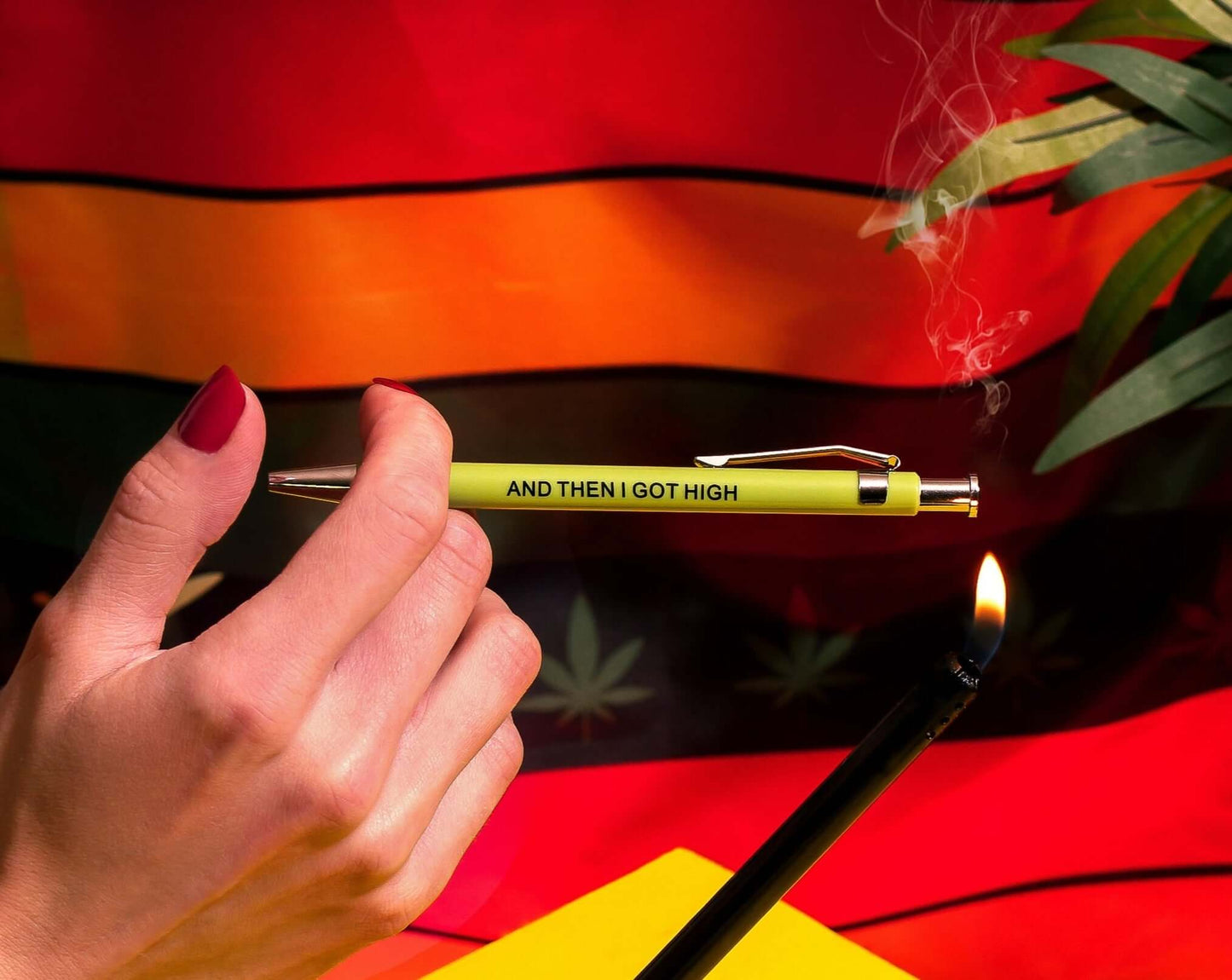 Funny pens with the phrase 'AND THEN I GOT HIGH' held in hand against a vibrant background.