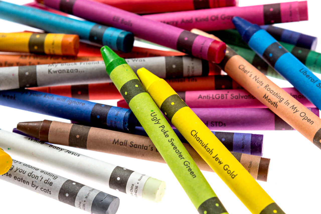 Colorful set of offensive crayons including ugly pLus sweater green and Chanukah low gold, perfect for holiday humor.